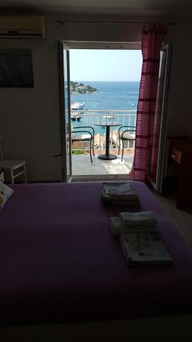 a bedroom with a bed and a view of the ocean at Apartments Boćin Rosso in Hvar