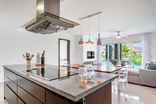 a kitchen and living room with a large island at Mareazul Beach Front Condos At playa del Carmen in Playa del Carmen