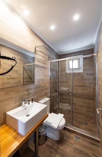 a bathroom with a white sink and a shower at Vista Del Diamante Apartments in Apolpaina