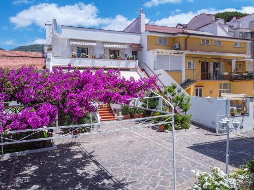 a view of a building with purple flowers at Villa Iolanda in Piano di Sorrento