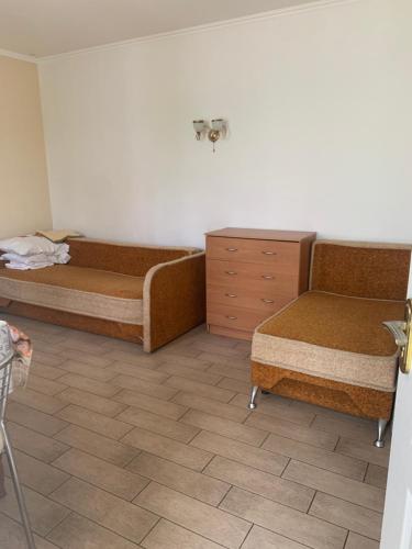 a room with two beds and a dresser at Cozy House on Vanceti Street in Odesa