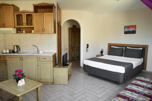 a bedroom with a bed and a kitchen with a sink at Atak Apart Hotel in Alanya
