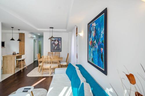 a living room with a couch and a dining room at A blok New Belgrade 2BD in Bežanija