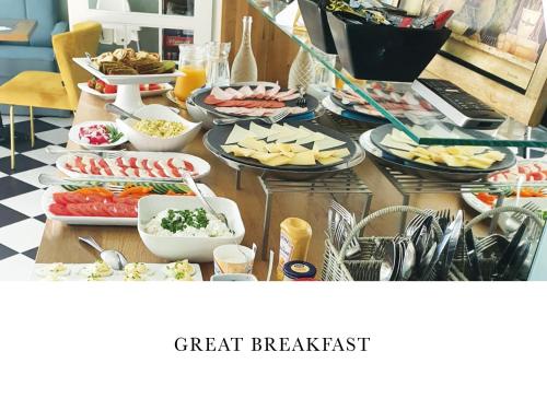 a table topped with lots of different types of food at Villa Antonina in Sopot