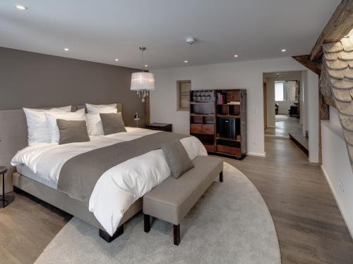 a bedroom with a large bed and a living room at Boutique - Hotel Adara in Lindau