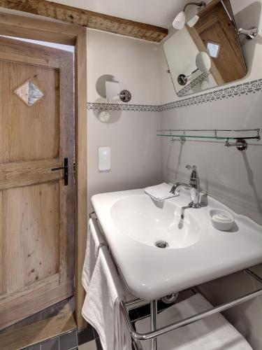 a bathroom with a white sink and a mirror at Boutique - Hotel Adara in Lindau