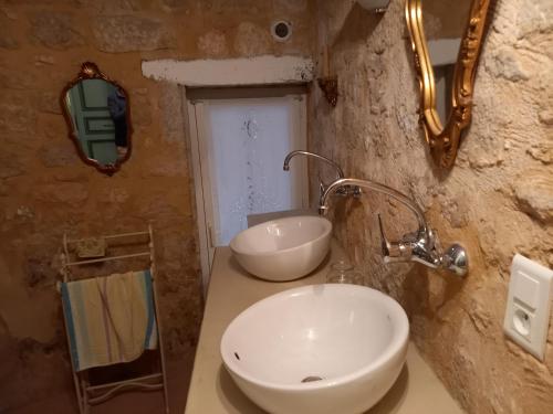 a bathroom with a white sink and a mirror at chambre d hôtes les remparts in Saint-Cyprien