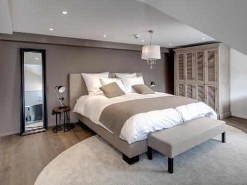 a bedroom with a large bed and a chair at Boutique - Hotel Adara in Lindau