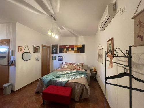 a bedroom with a bed and a red stool at Villa Mihaela in Fažana