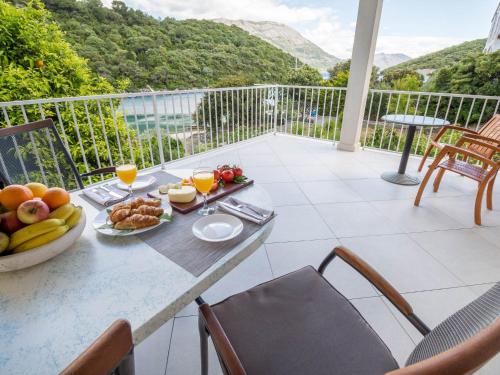 a table with a bowl of fruit on a balcony at Apartment Karla in Korčula