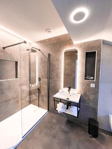 a bathroom with a sink and a shower at Penzion Jakub in Lanškroun