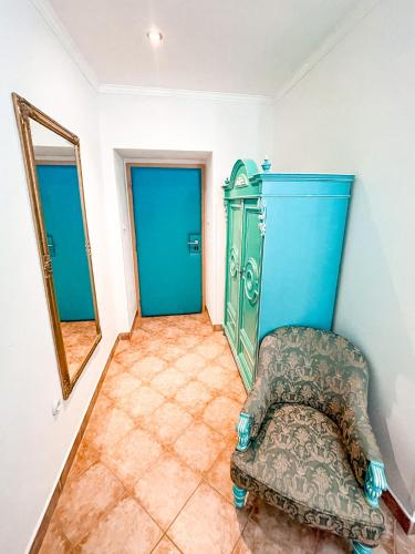 a room with a chair and a mirror at Penzion Jakub in Lanškroun
