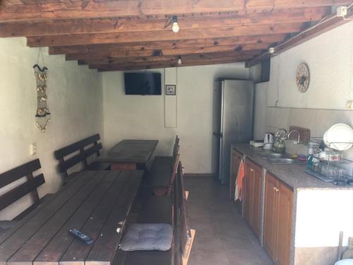 a kitchen with a table and a counter in a room at Chervenkov Guest House in Chernomorets