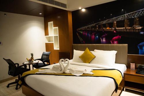 a hotel room with a bed with swans on it at Hotel Namo Residency in Vijayawāda
