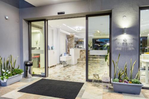 a lobby with glass doors and potted plants at Patiras Deluxe B&B in Limenaria