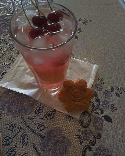 a drink with a monkey cookie on a napkin next to at Guest House Armina in Yerevan