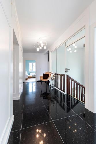 a living room with a black floor and a table at PRIMERA Villa in Singen