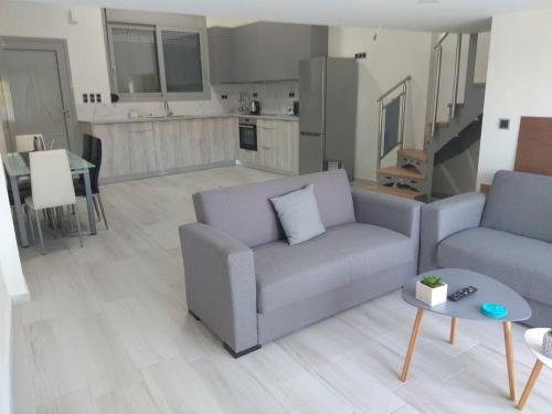 a living room with a couch and a table at Malamatenia 's Maisonette in Mokhós