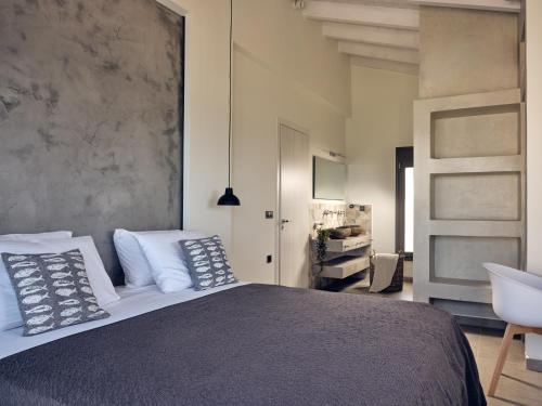 a bedroom with a large bed and a sink at LaLune SeaSide Villa, Zante Zen By ThinkVilla in Kipseli