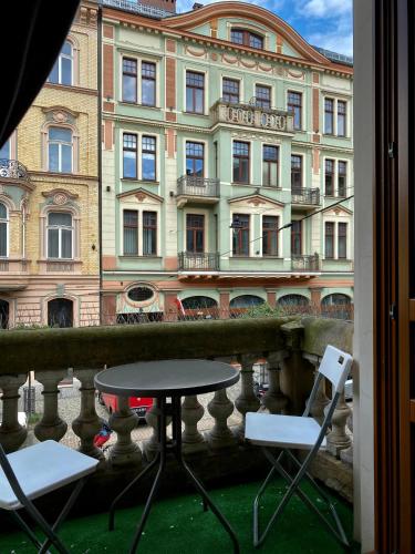 a table and chairs in front of a building at Ametyst Apartments in Krakow
