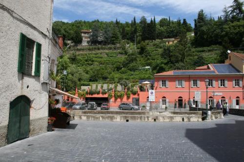 a street in a town with buildings and trees at Casa vacanze gli ulivi in Borgomaro