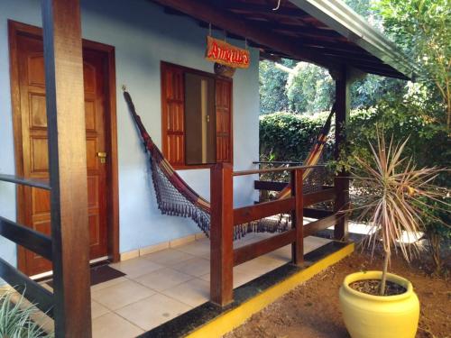 a porch of a house with a hammock on it at Pousada Licuri in Serra do Cipo