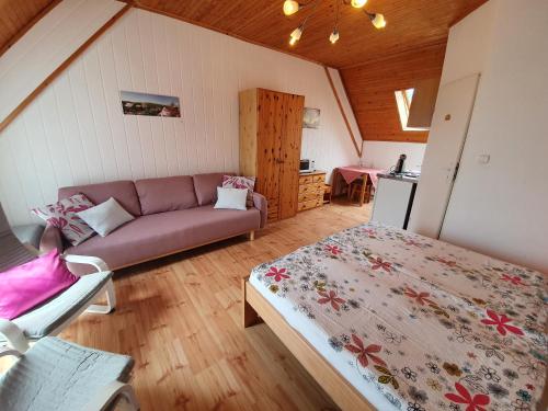 a living room with a couch and a bed at Žltý dom Vrbov in Vrbov