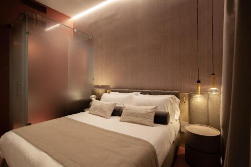 a bedroom with a large white bed with two pillows at Palazzo Pianca in Venice