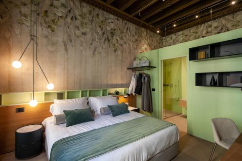 a bedroom with a large bed and a green wall at Palazzo Pianca in Venice