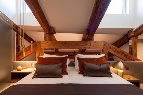 a bedroom with a large bed with brown pillows at Palazzo Pianca in Venice