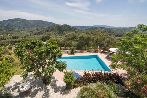 an aerial view of a swimming pool with mountains in the background at Villa PANGALIS Romantica in Kato Pavliana