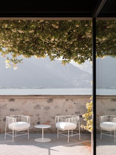 a group of chairs and a table in front of a window at Casa Olea Hotel in Cremia