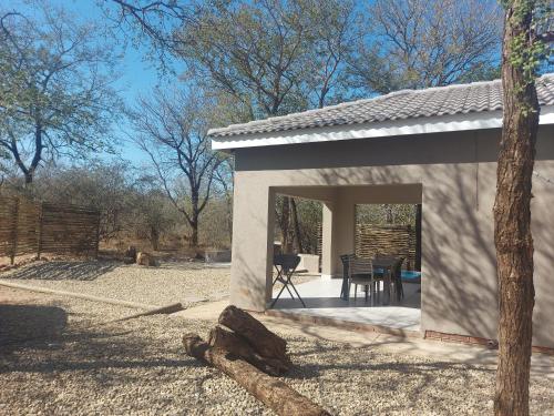 a small white building with a table and chairs in it at 3714 @Ribbok in Marloth Park