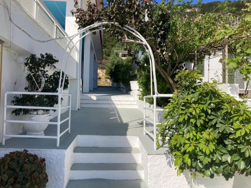 a hallway with plants and an arbor in a building at Hotel Galini in Póros Kefalonias