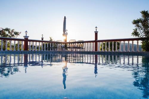 a swimming pool in front of a fence at Villa PANGALIS Romantica in Kato Pavliana