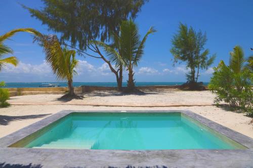 a swimming pool in the middle of a beach at Kikoi Boutique Hotel in Michamvi