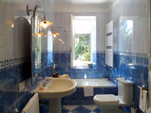 a bathroom with a tub and a sink and a toilet at La Casa di Anny camere di Charme in Diano Marina