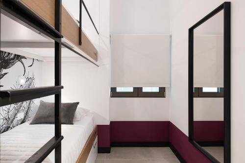 a small bedroom with a bunk bed in a loft at Cocoon City Hostel in Chania Town