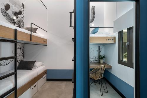 a small room with a desk and bunk beds at Cocoon City Hostel in Chania Town