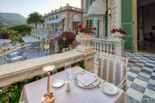 a table and chairs on a balcony of a building at Imperiale Palace Hotel in Santa Margherita Ligure