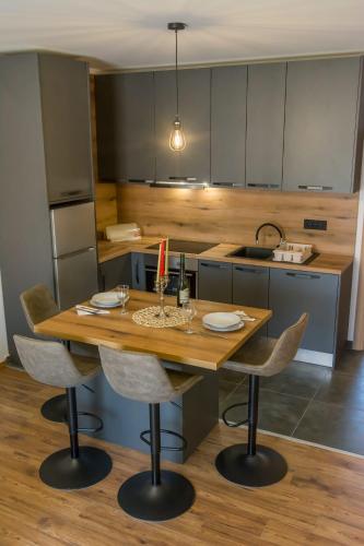a kitchen with a wooden table and chairs at Apartman Joso 2 in Sukošan
