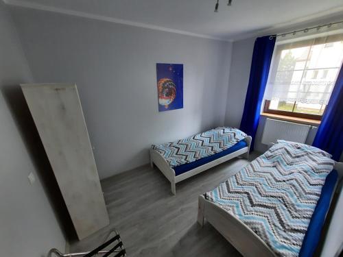 a room with two beds and a window at Na Starówce 1 in Żywiec