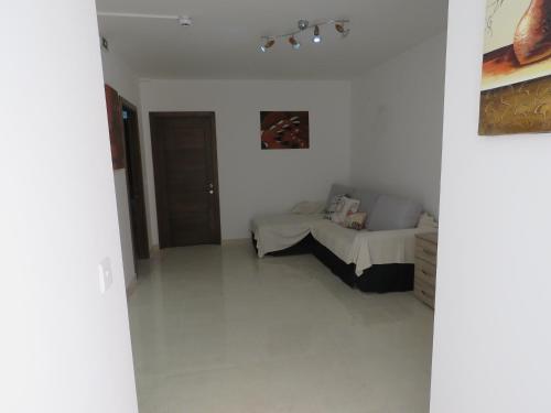 a bedroom with a bed in a white room at Aquamarine Sea Front Apartments - Second Floor in Marsaskala