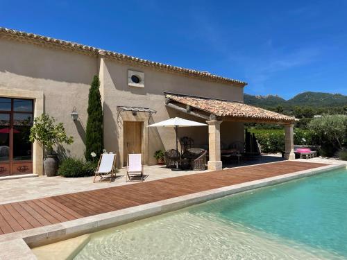 une maison avec une piscine devant une maison dans l'établissement Ferienhaus Côté Dentelles am Fuß der Dentelles de Montmirail, à Vacqueyras