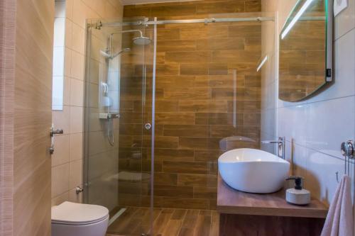a bathroom with a sink and a glass shower at Apartman Joso 3 in Sukošan