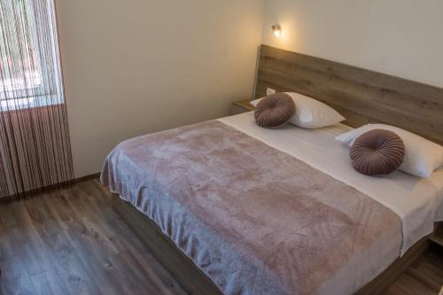 a bedroom with a bed with two pillows on it at Apartman Joso 3 in Sukošan
