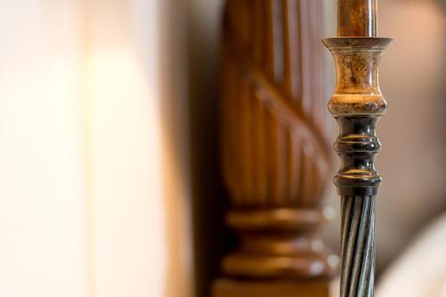 a close up of a wooden stair rail with at Burton Court in Dilwyn