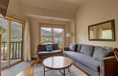 a living room with a couch and a table at CS407 Copper Springs condo in Copper Mountain
