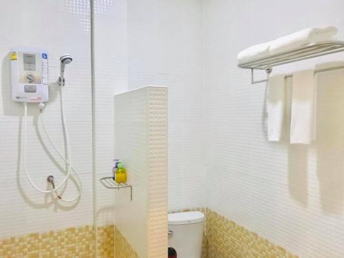 a shower in a bathroom with a toilet and a glass door at อันตงเพลส Anton place in Ban Pa Ngiu