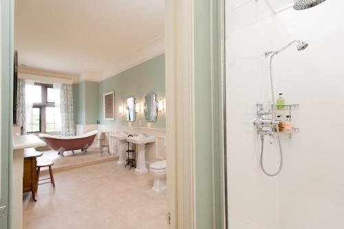 a bathroom with a bath tub and a claw foot bath tub at Burton Court in Dilwyn
